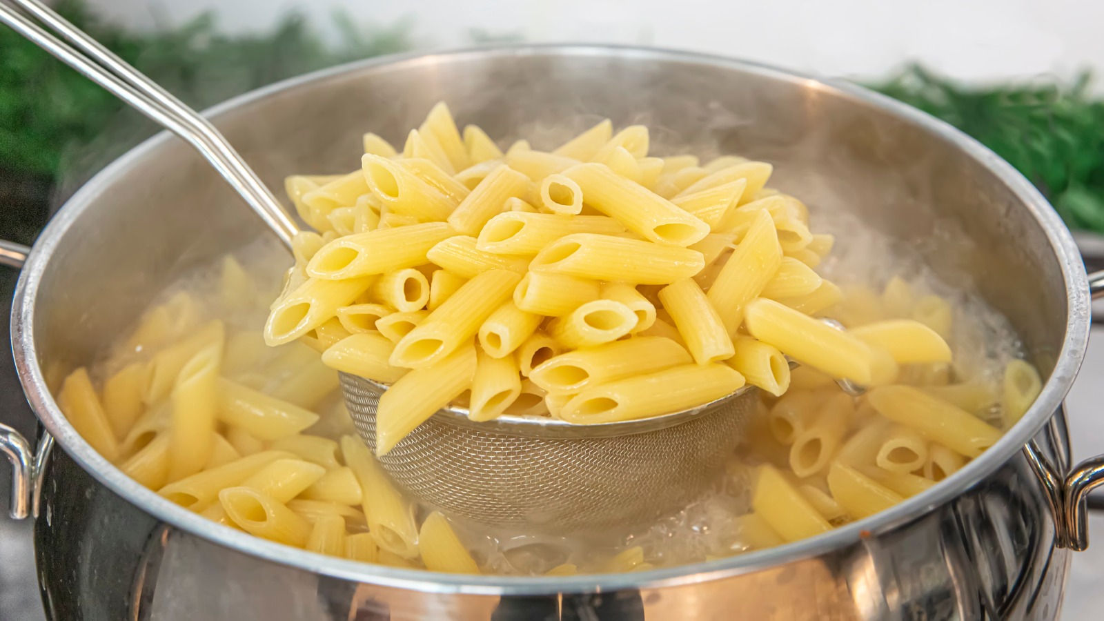 Cooking,Pasta,Pour,The,Penne,Pasta,Into,A,Metal,Pot